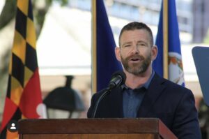 Michael DelBene speaking at a podium.